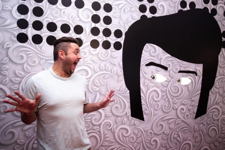 A person participating in an exhibit at the Paradox Museum.