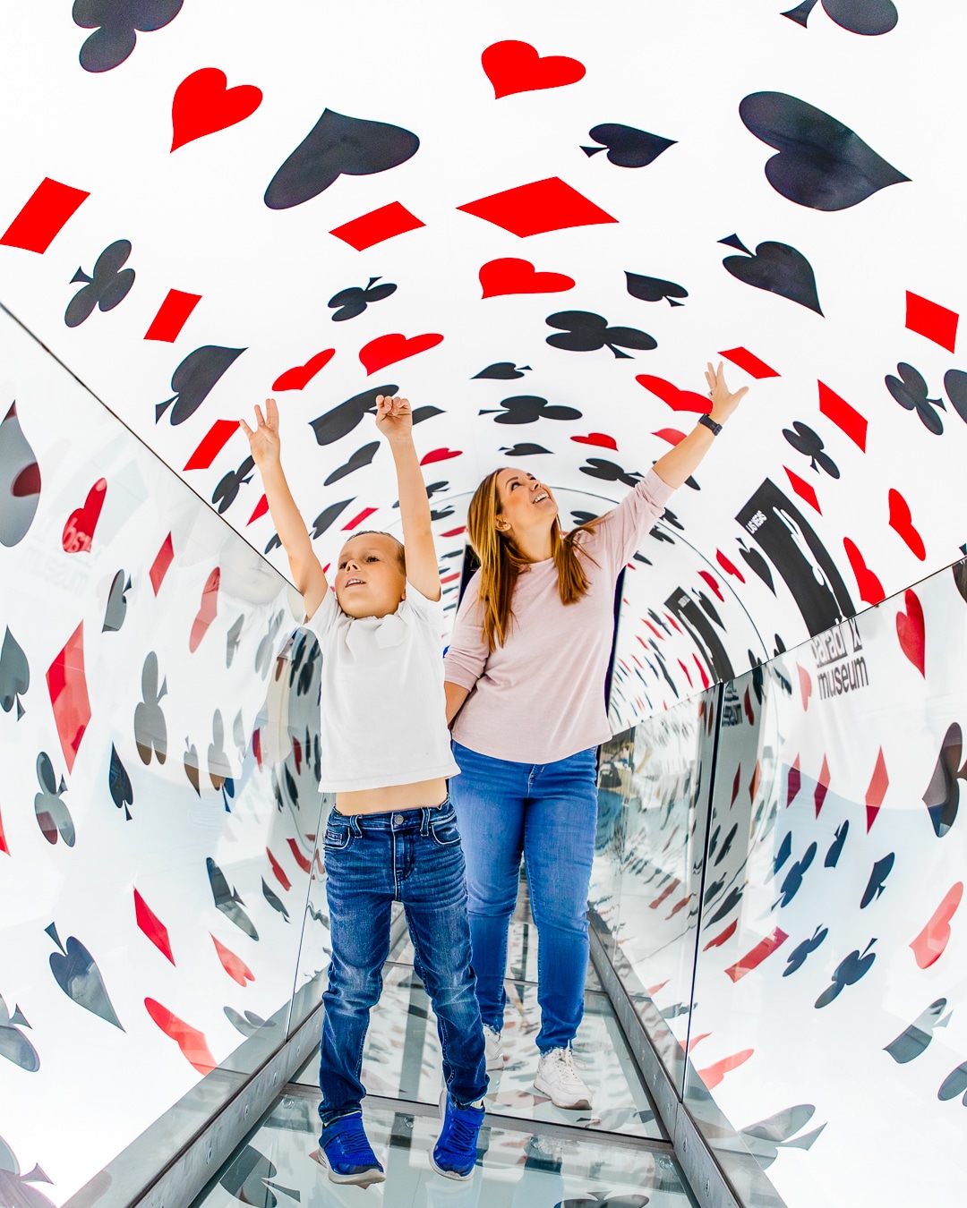A mother and son exploring an exhibit at Paradox Museum.