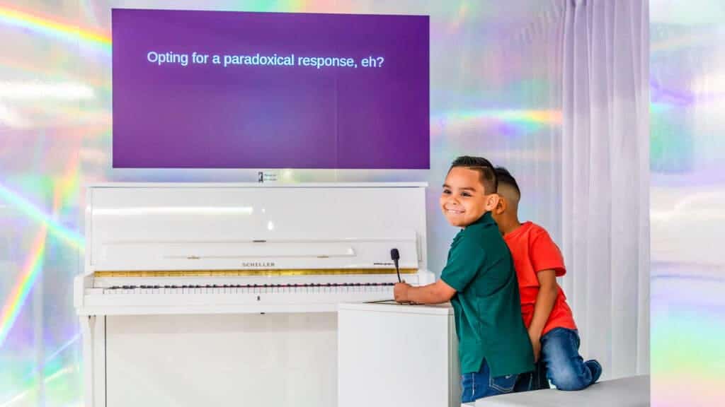 Two kids interacting with an exhibit at the Paradox Museum.