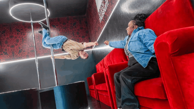 Two people enjoy a Paradox Museum exhibit together.