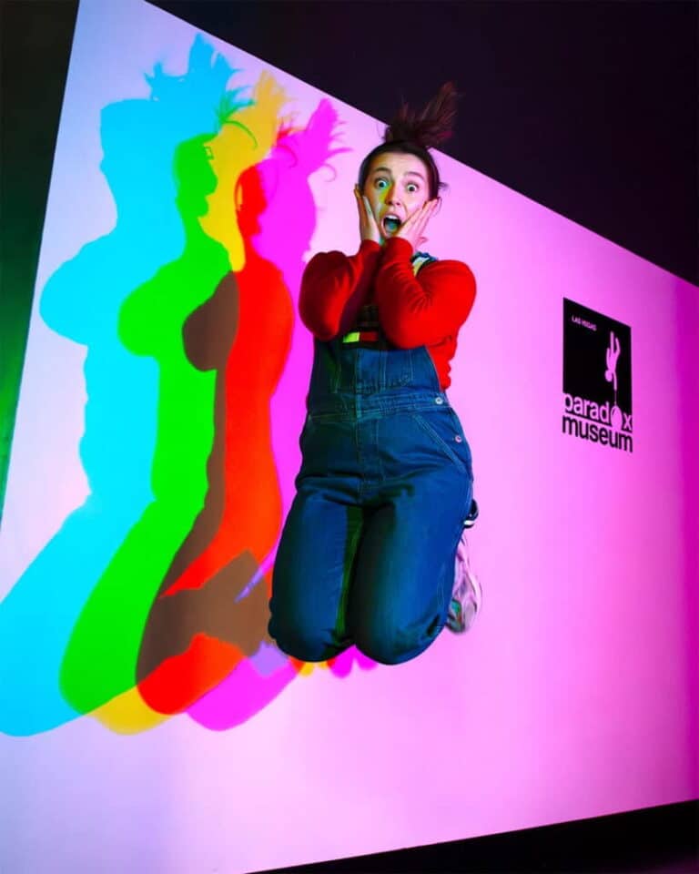 A woman jumping during an exhibit at the Paradox Museum.