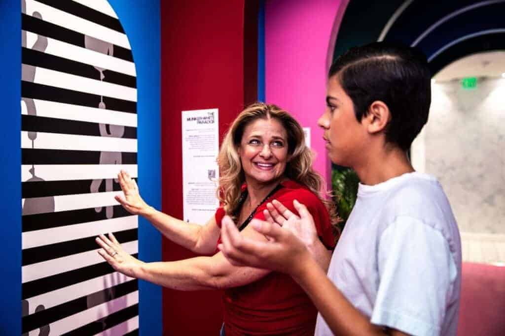 A mother and son experiencing a Paradox Museum exhibit together.